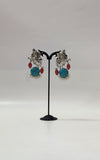 Radha Krishna Oxidized Silver Earrings with Turquoise Stone, Red Accents & Pearls
